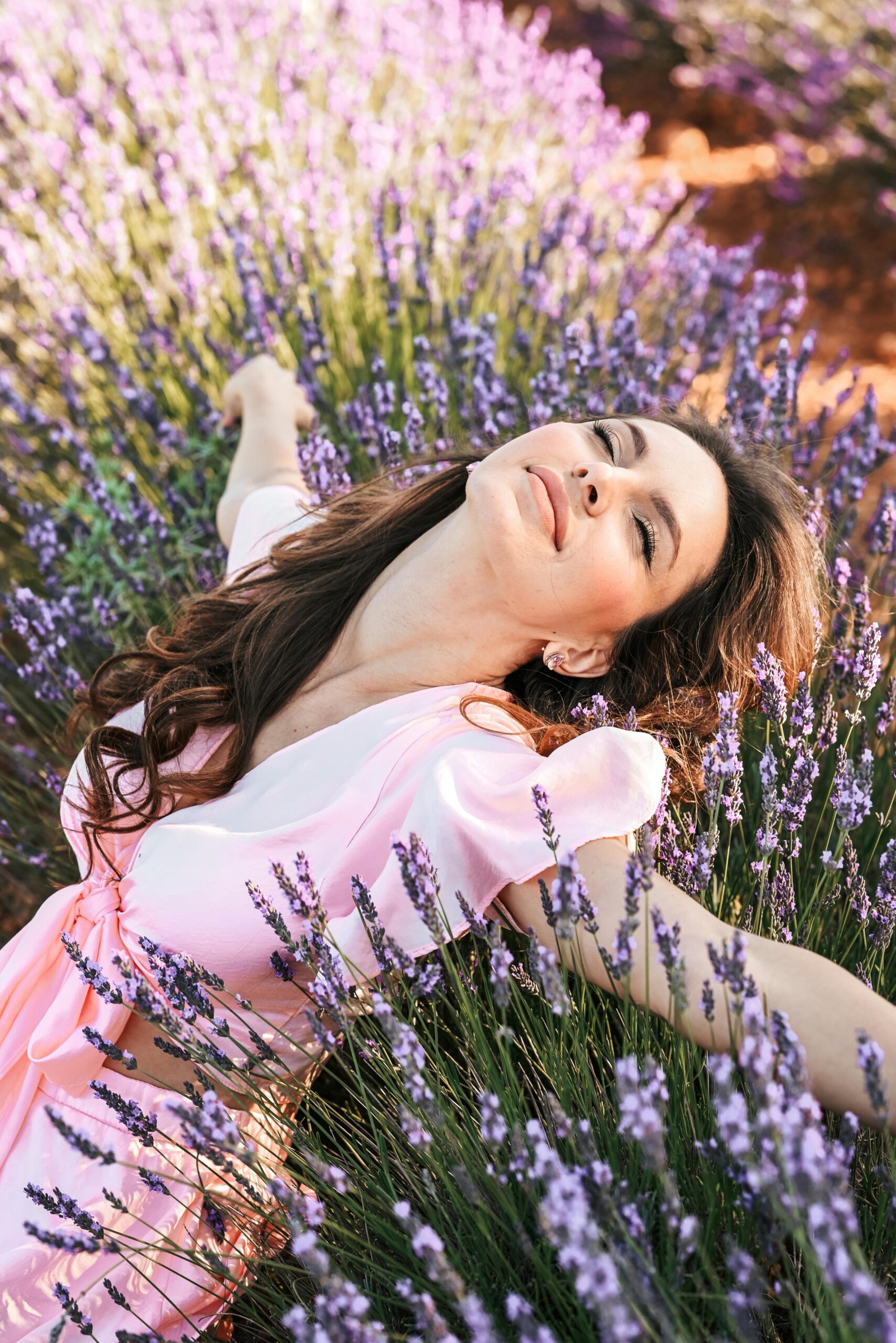 Woman in flowers, blissed out. How to Align with What You Want. The Deeper Self Podcast