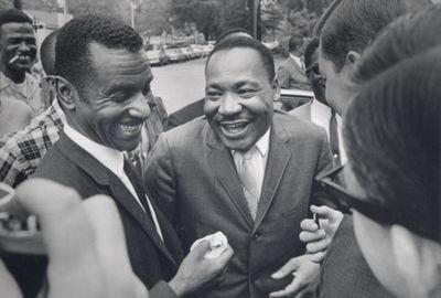 MLK smiling with friends. Spiritual Protest